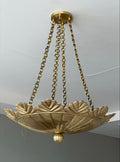 Brushed brass scallop pendant light hanging from chain
