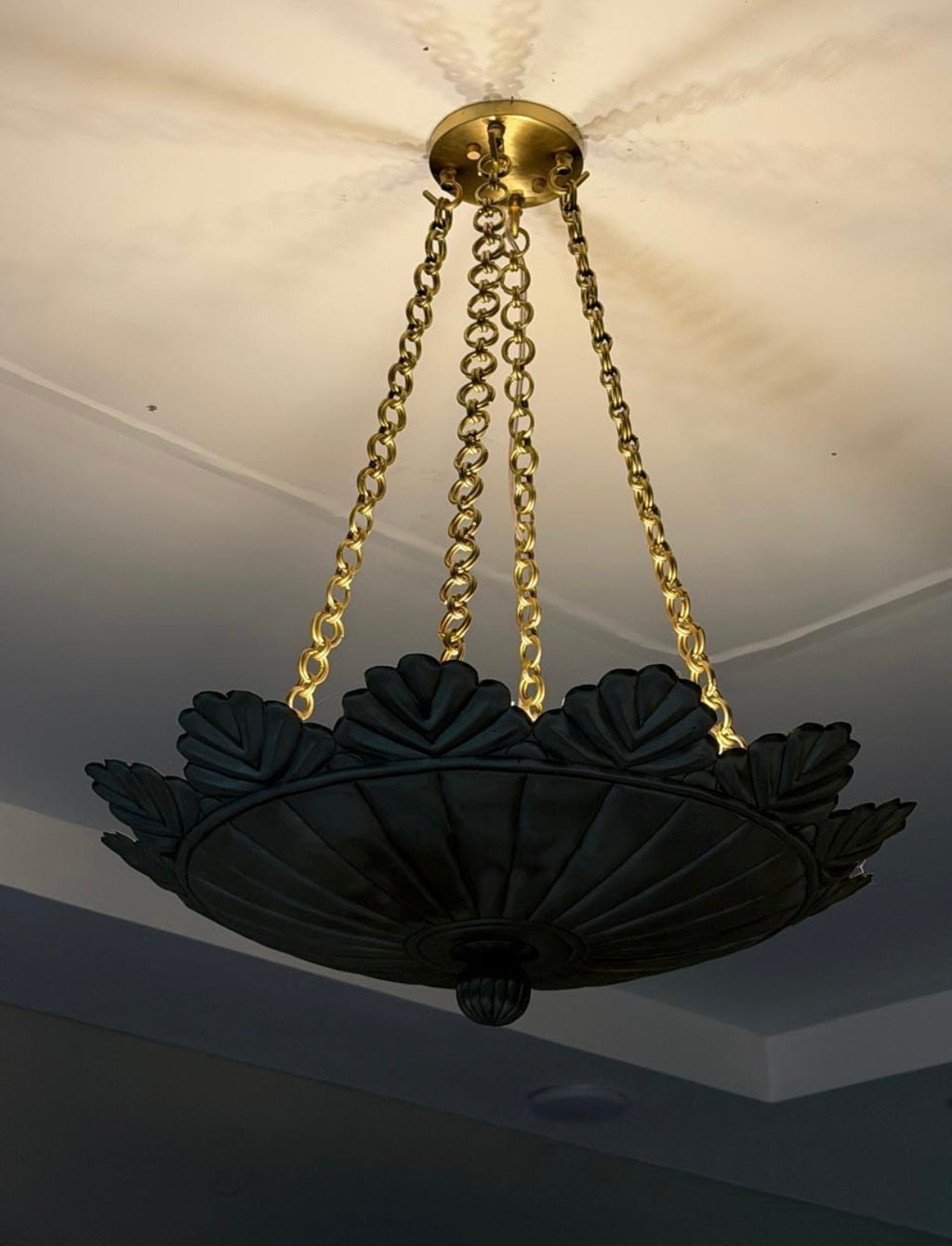 Brushed brass scallop pendant light illuminated