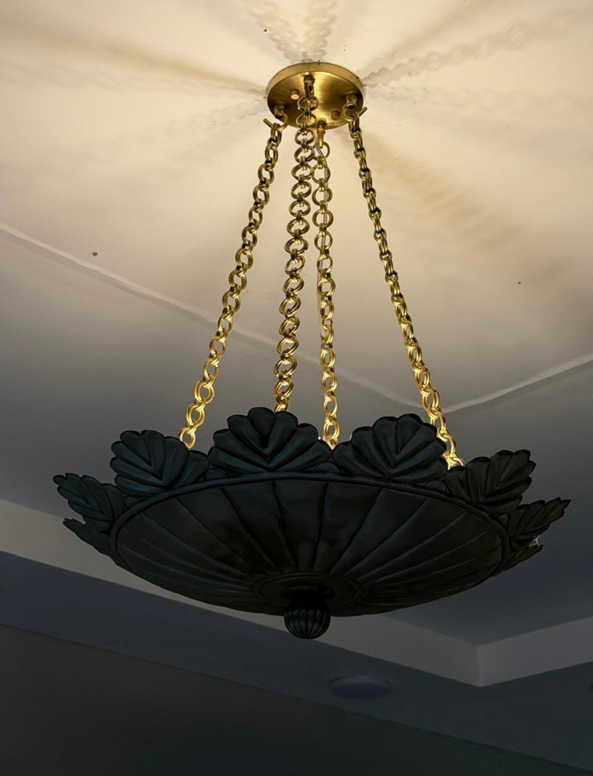 Brushed brass scallop pendant light illuminated