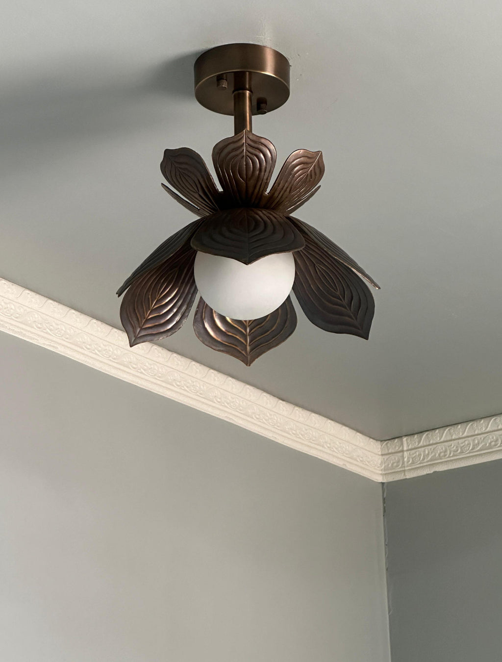 Antique brass lotus flower flush mount ceiling light with glowing glass globe