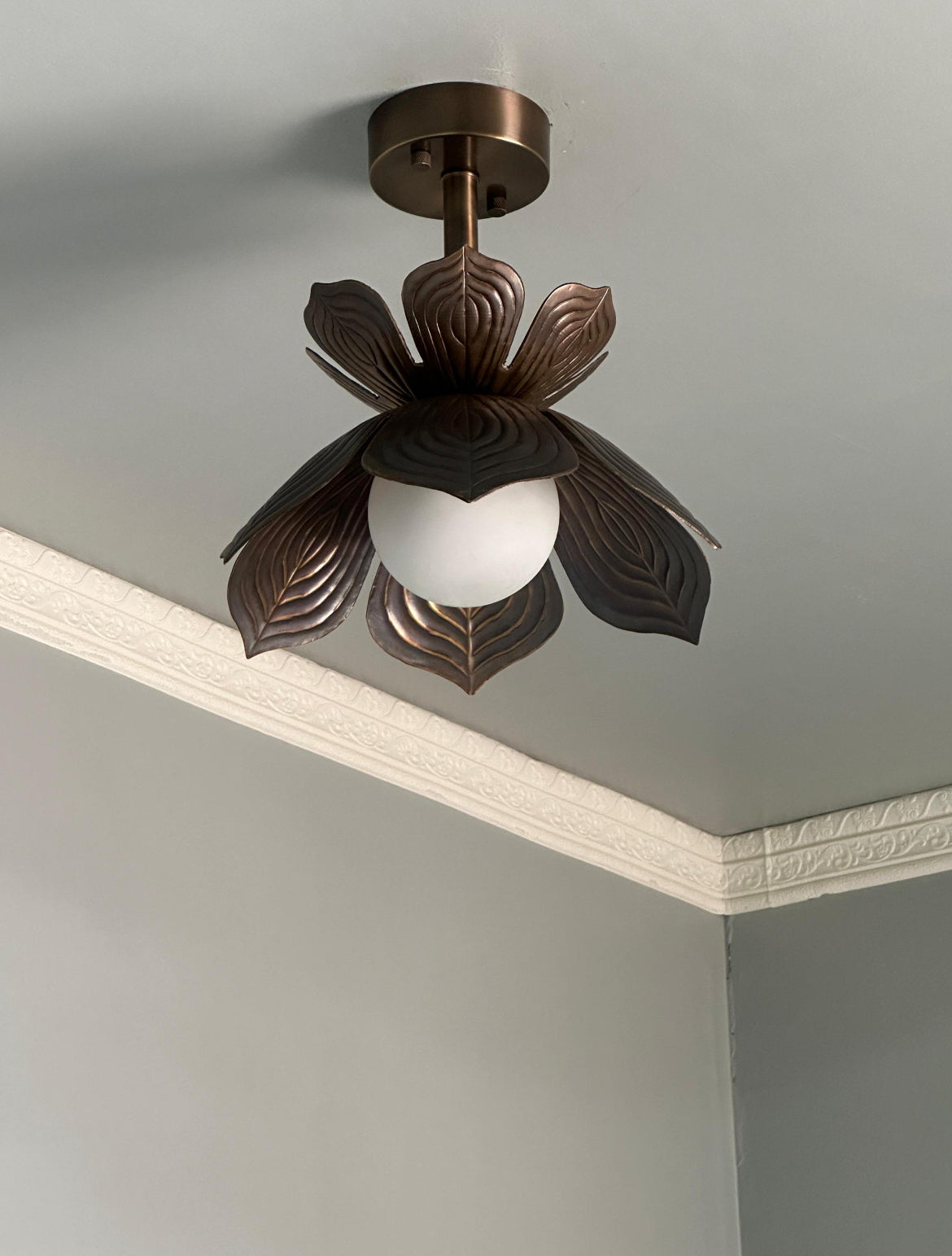 Antique brass lotus flower flush mount ceiling light with glowing glass globe