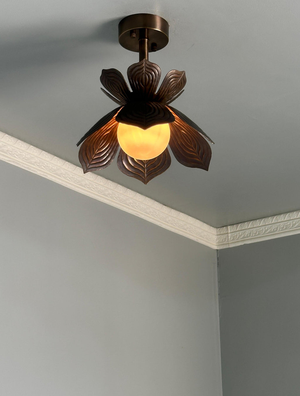 Antique brass lotus flower flush mount ceiling light with glowing glass globe