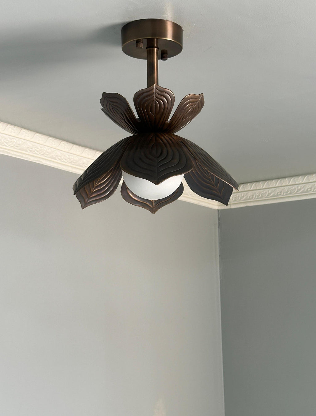 Antique brass lotus flower flush mount ceiling light with glowing glass globe