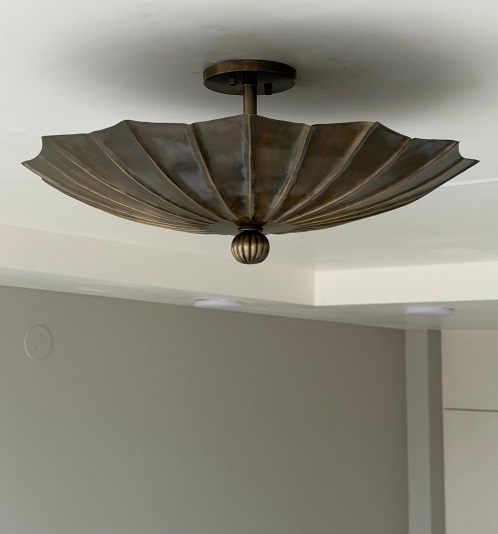 Antique brass fluted flush mount light with folded petal shade