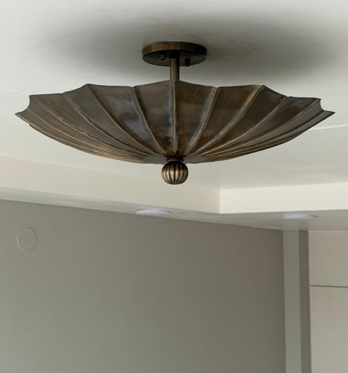 Antique brass fluted flush mount light with folded petal shade