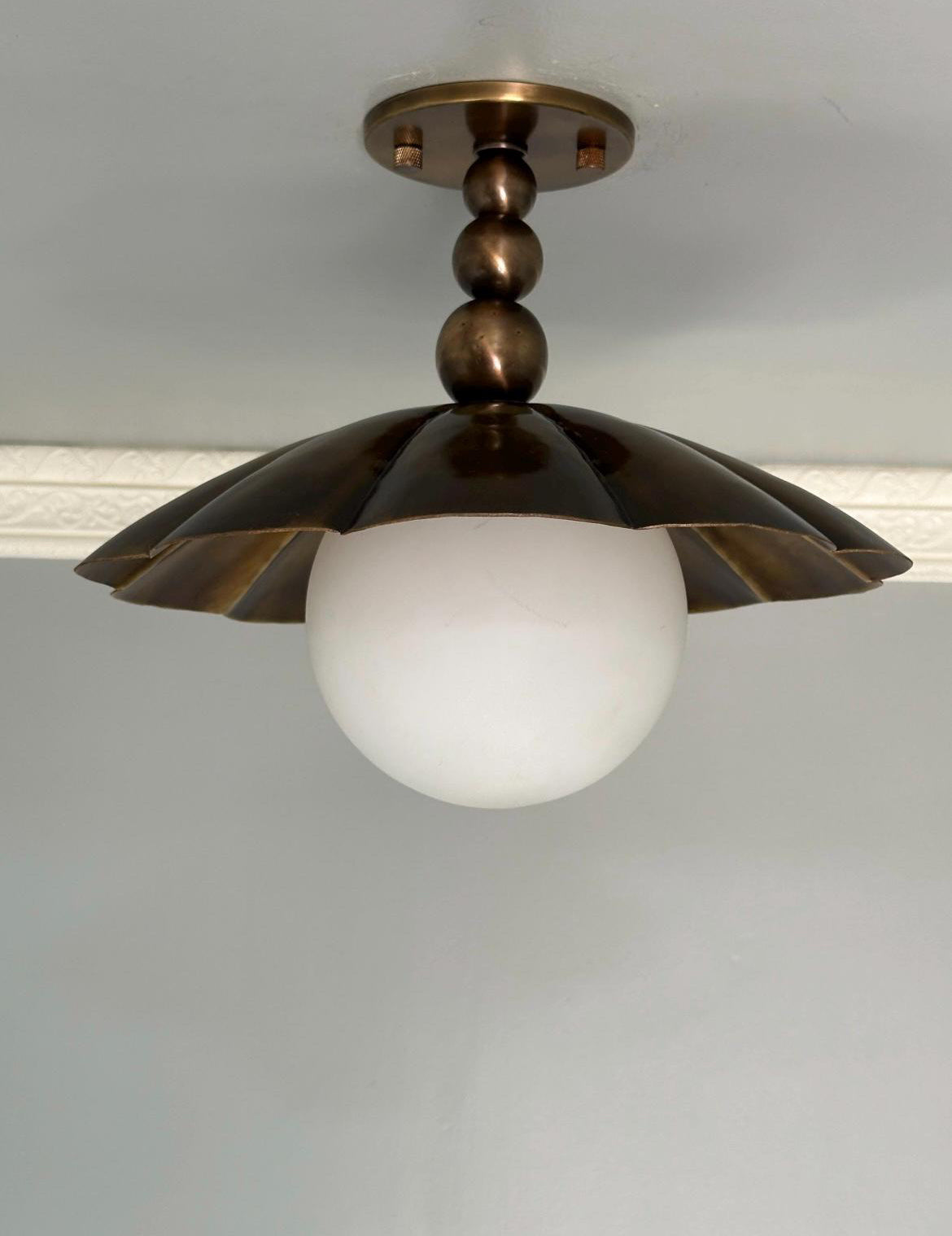 Antique brass scalloped semi flush mount ceiling light with frosted milk glass globe