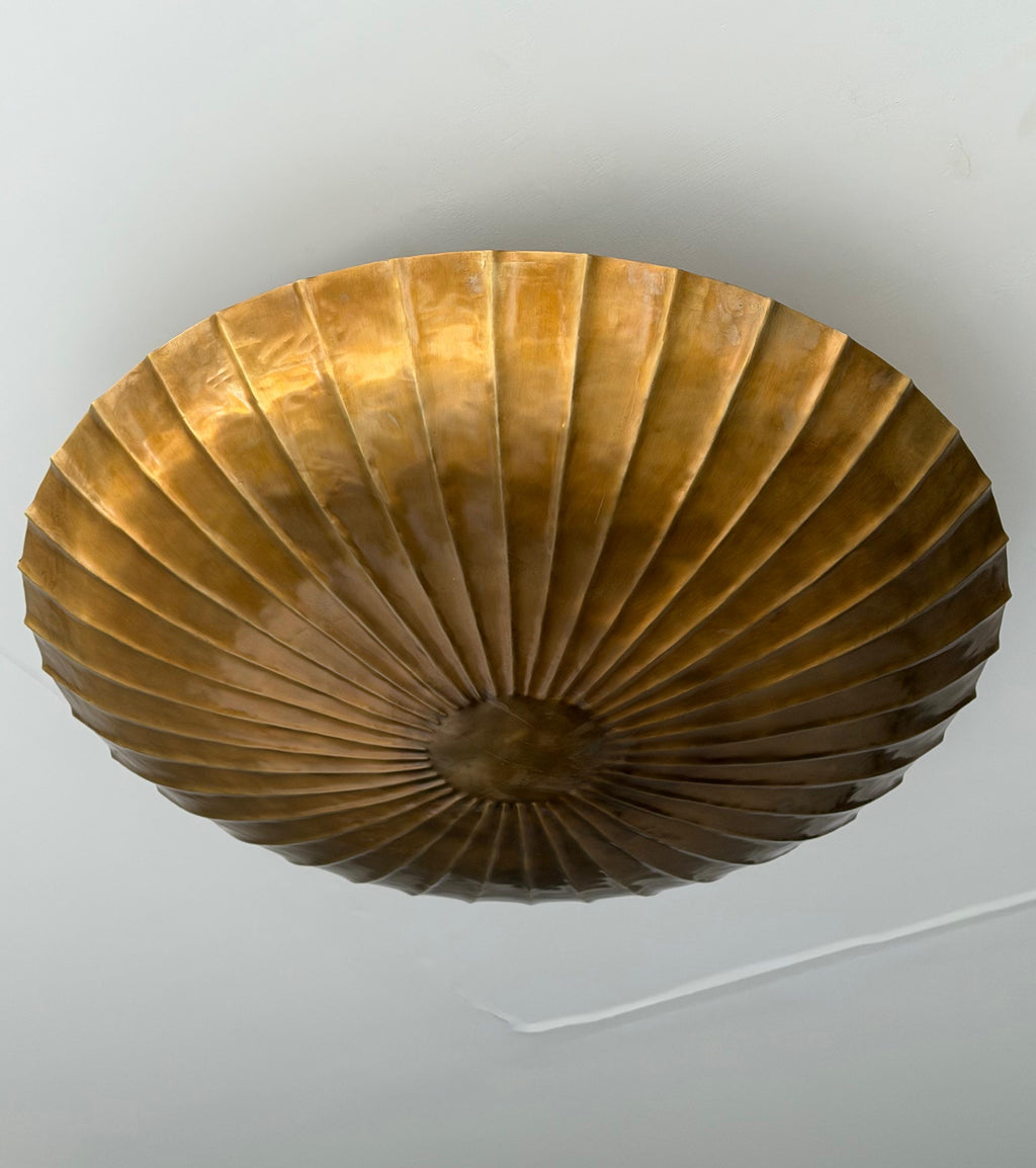 Antique brass fluted ceiling light installed on ceiling