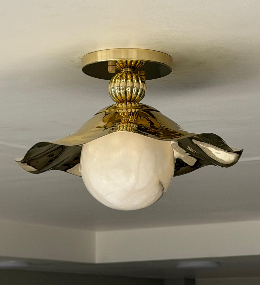 Gold brass ruffled flush mount with alabaster globe - closeup view