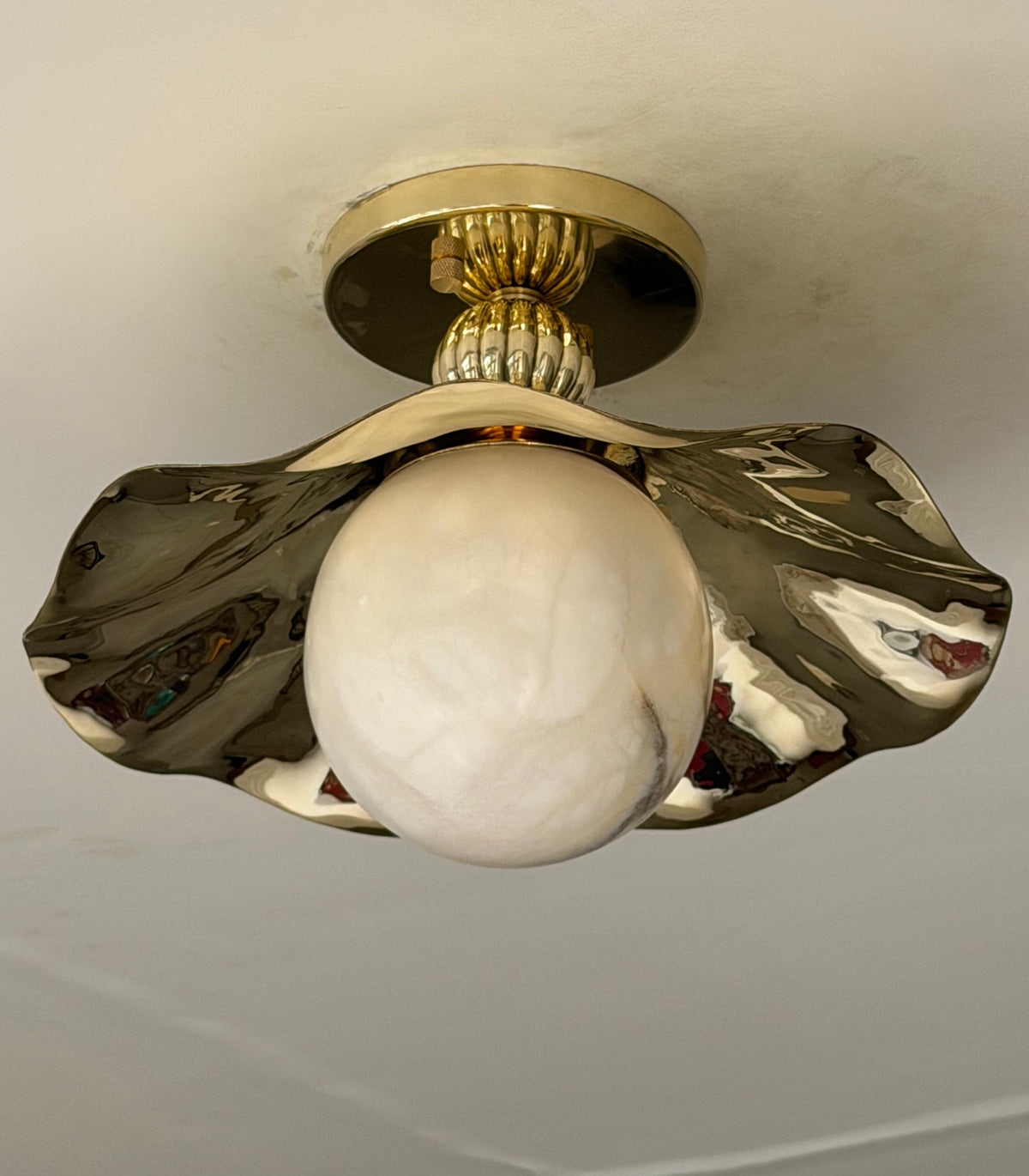 wavy flush mount light with alabaster globe close up picture