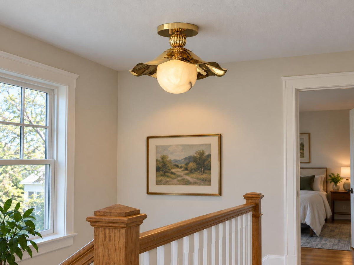 Brass wavy flush mount ceiling light in farmhouse stairway