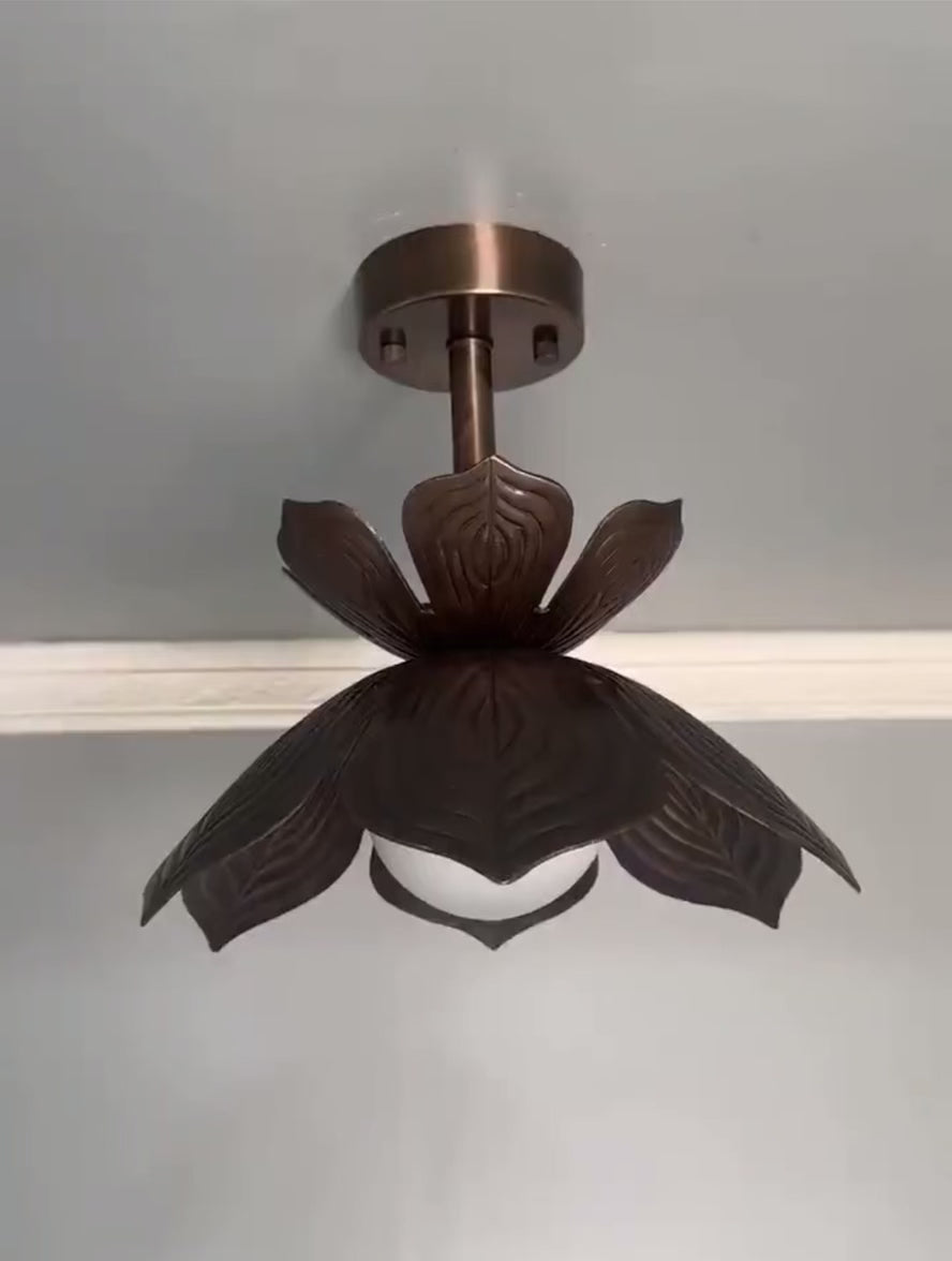 Antique brass lotus flower flush mount ceiling light with glowing glass globe